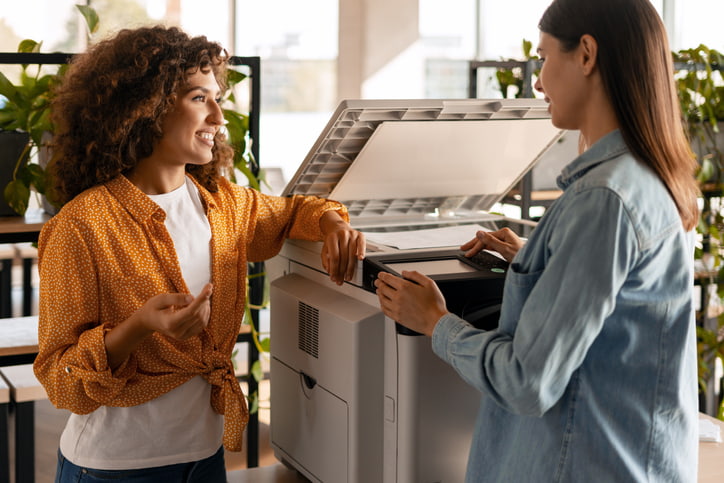 Two professionals discussing a copier in an office workspace in Palm Coast, FL