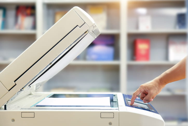 Person using a photocopier for document copying and printing in Palm Coast, FL