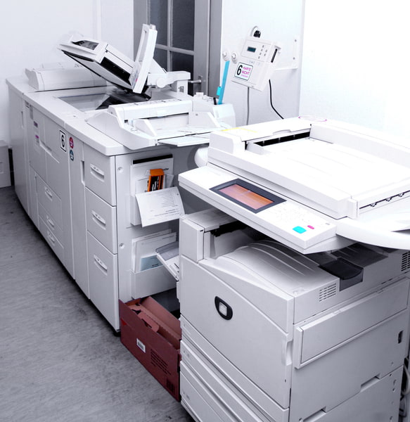 Industrial copier and printer machines in a document production room in Port Orange, FL